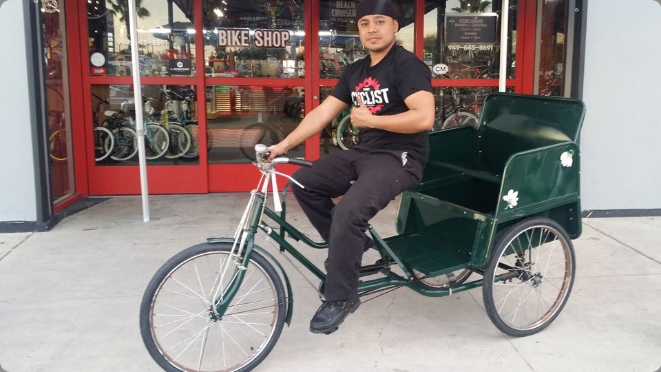 Restored vintage green rickshaw bike