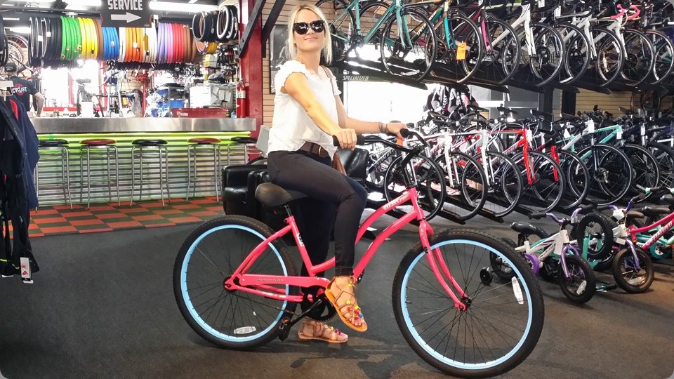 Pink cruiser bike with blue rims