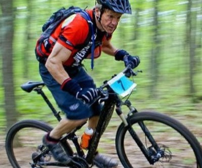 Older man racing a mountain bike