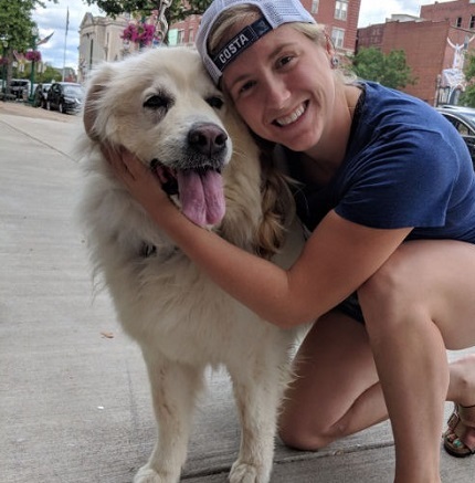 Girl posing with a white dog