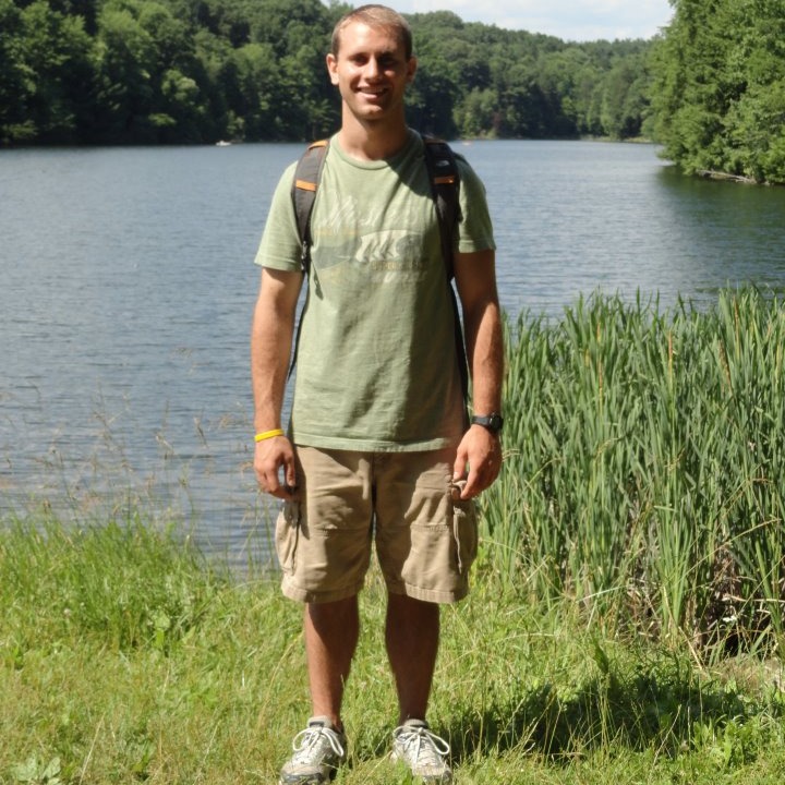 Man posing in front of a river