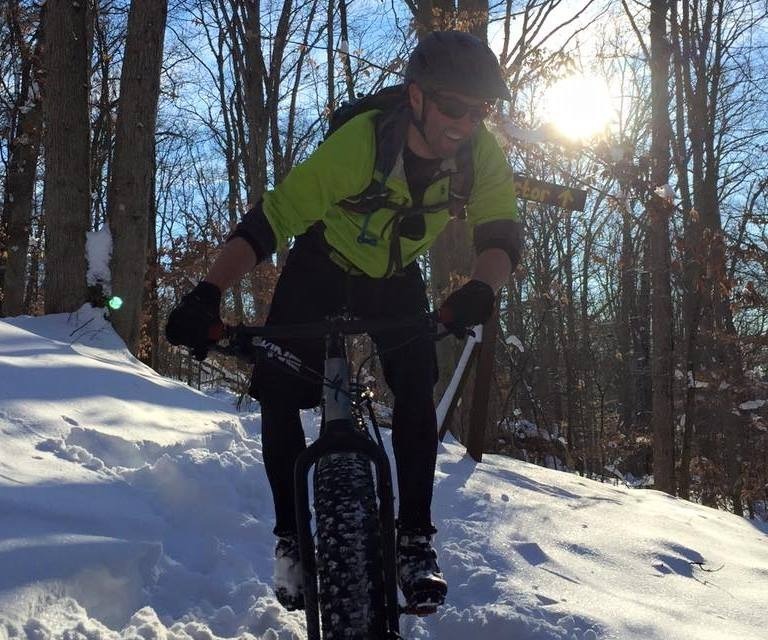 Man riding bike in the snow