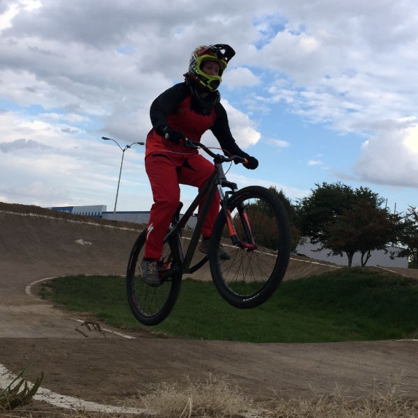Woman jumping a mountain bike on a pump track