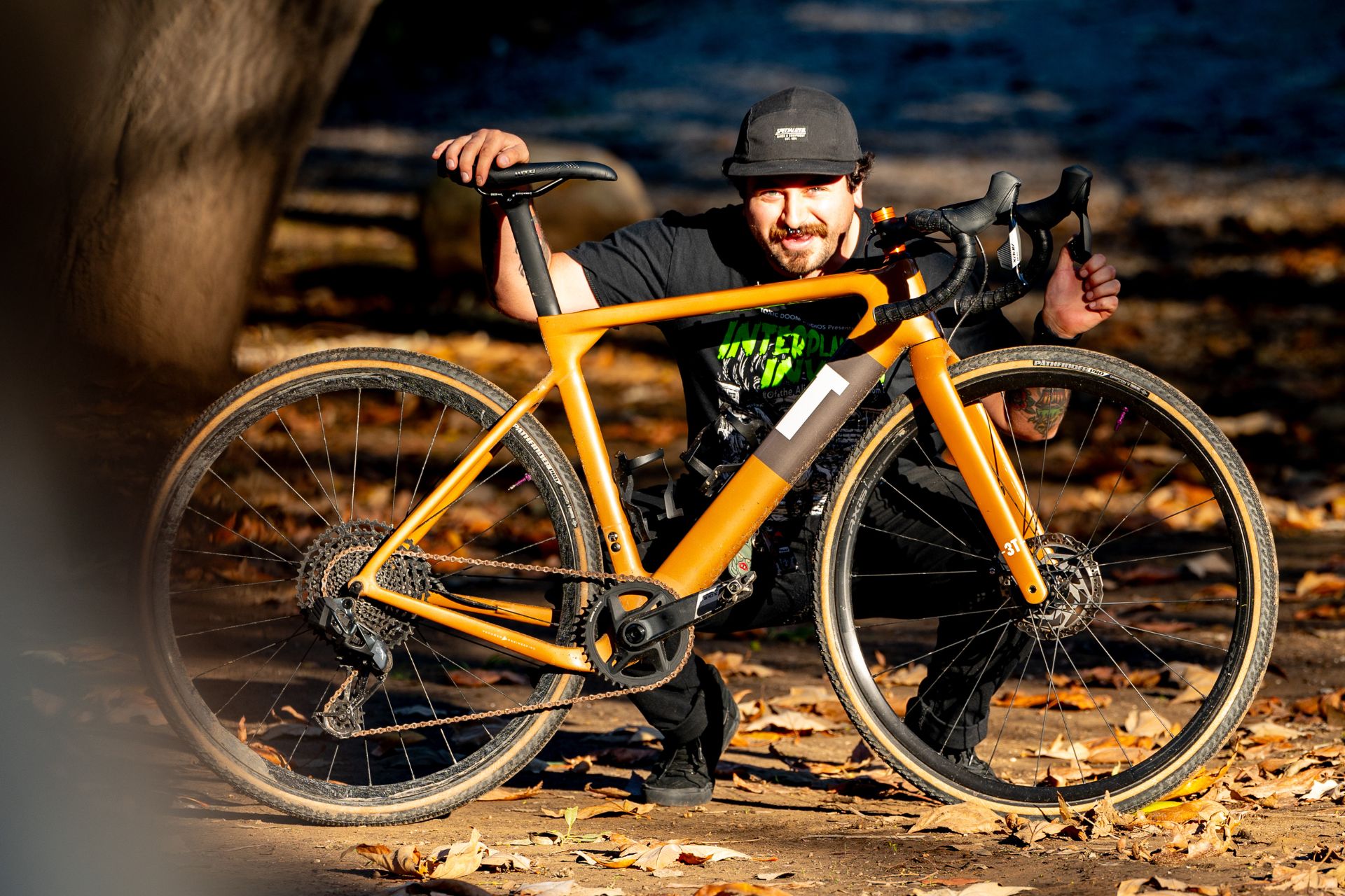 Brian Szumski crouches behind his new orange 3T Primo Exploro gravel bike