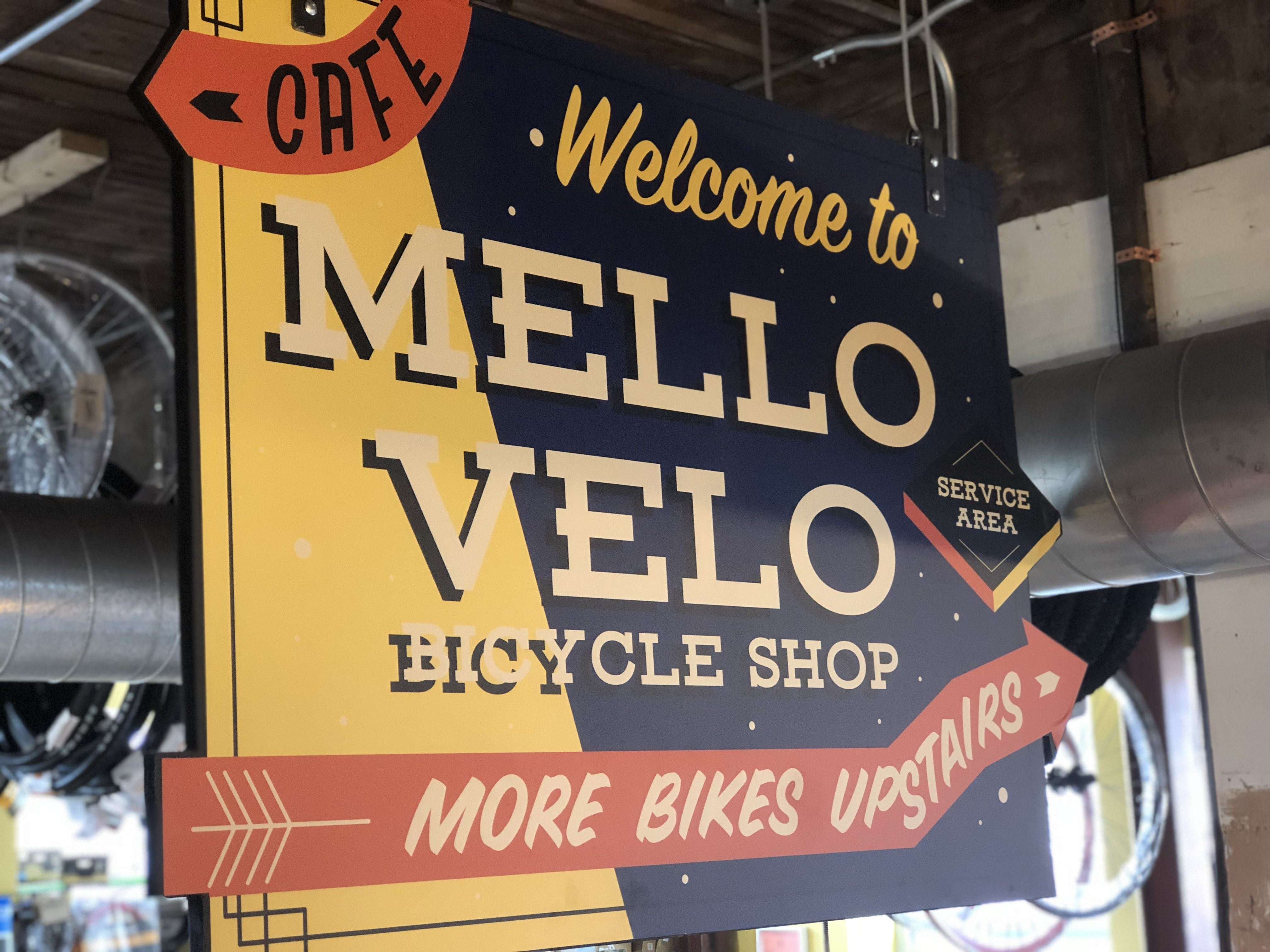 Welcome to Mello Velo Bicycle Shop Sign