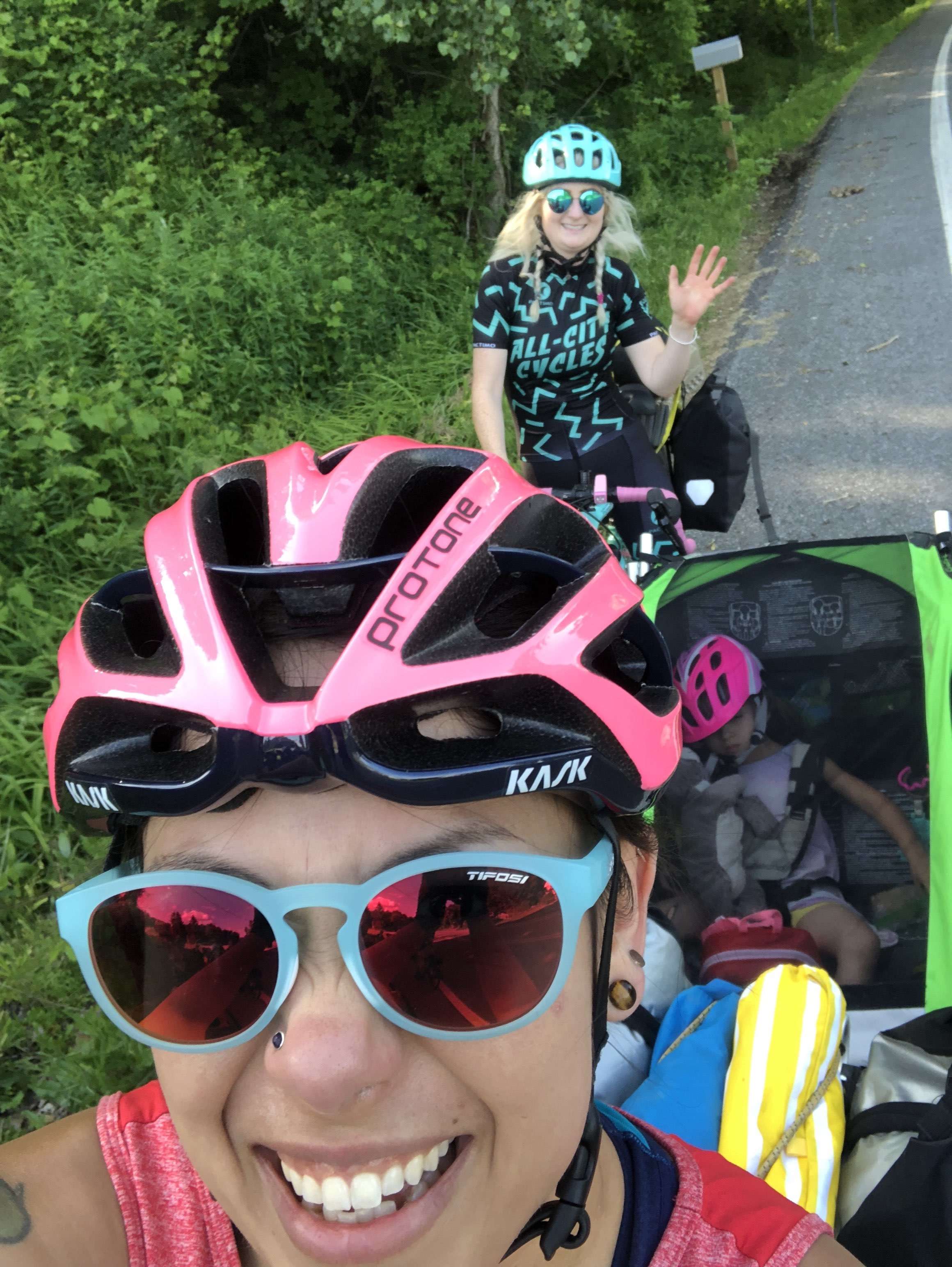 Selfie of female cyclists waving at the camera