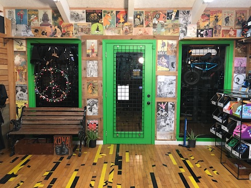 Interior of current location with mural, upcycled flooring, and colorful merchandise