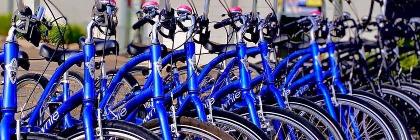 Row of blue townie bikes in front of bike store
