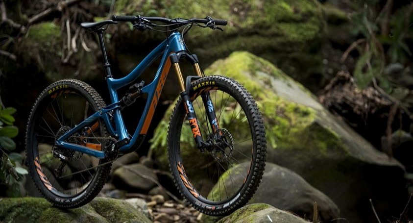 Blue and orange Ibis mountain bike in outdoor forest setting