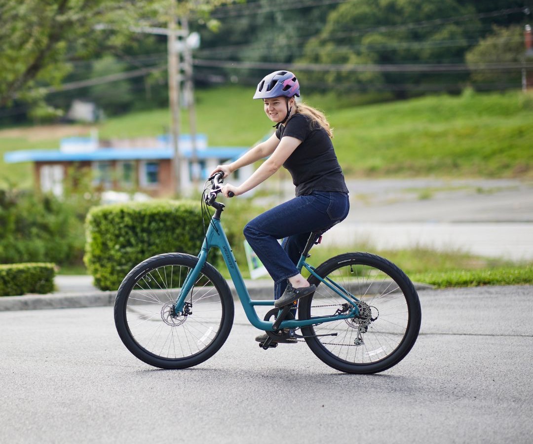 Salesperson helping girl with bike