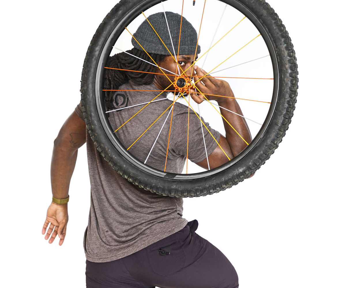 Another Industry Nine employee holding a wheel. 