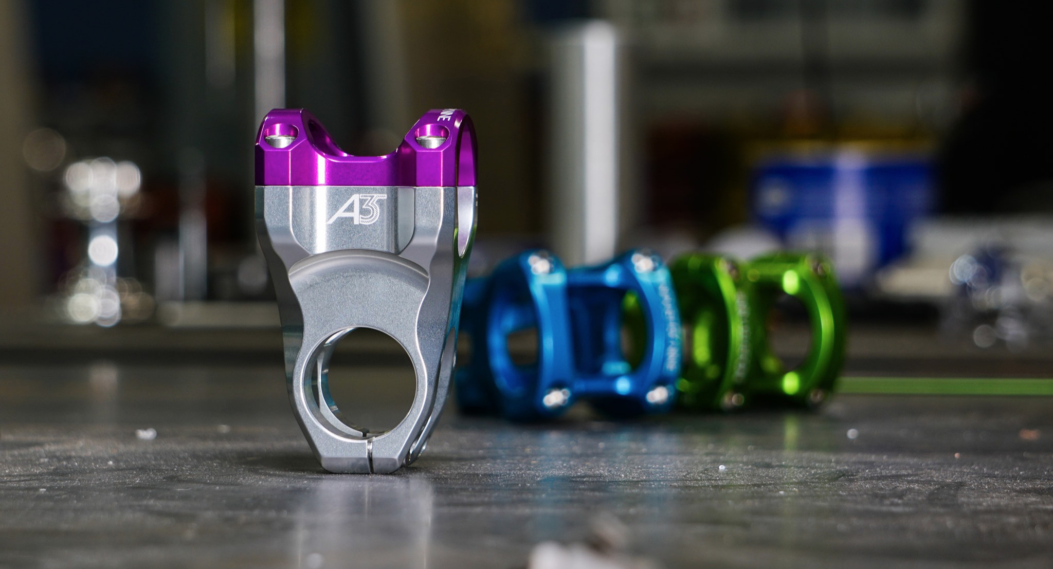 Three Industry Nine stems, one silver with purple, one light blue, and one green. 