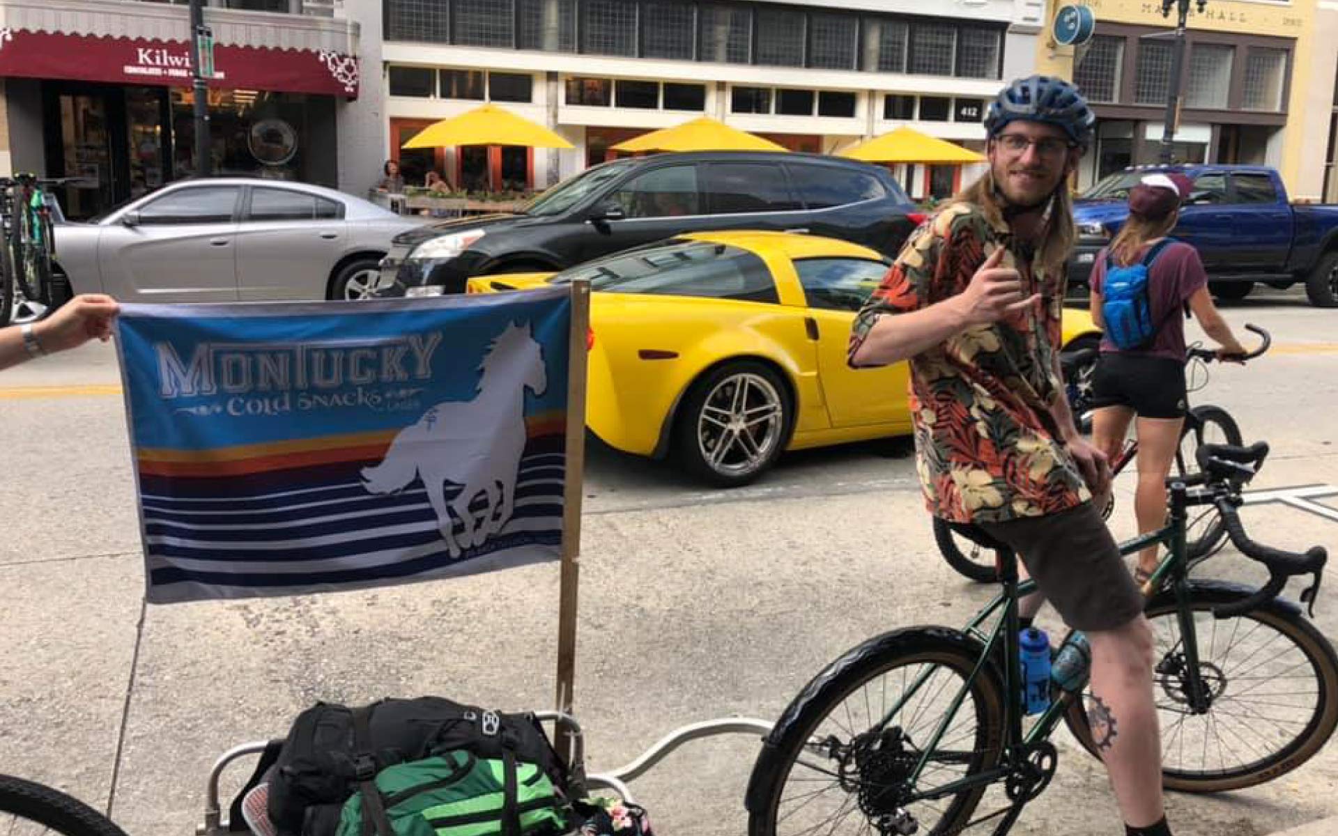 Evan on his bike in downtown Knoxville with a Montucky flag behind his bike