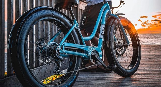 woman standing over a comfort bike