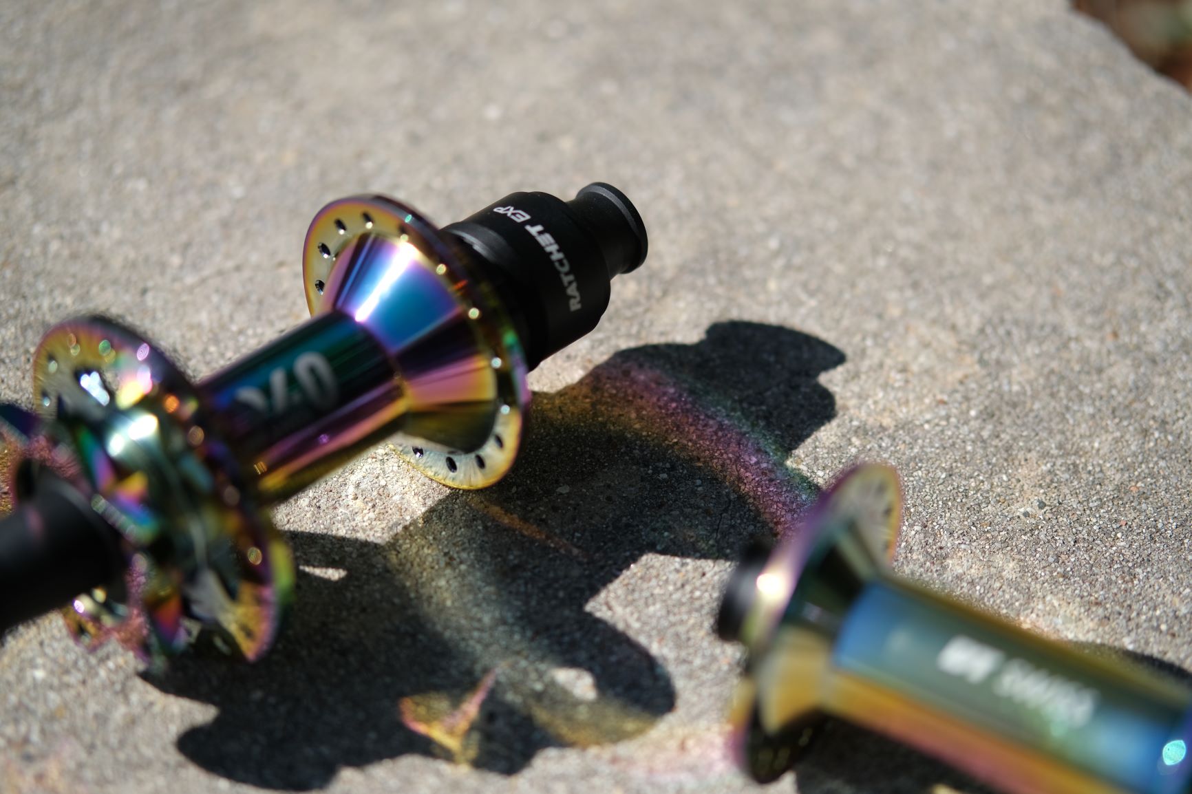 A pair of DT Swiss oil-slick hubs throw a rainbow onto the ground