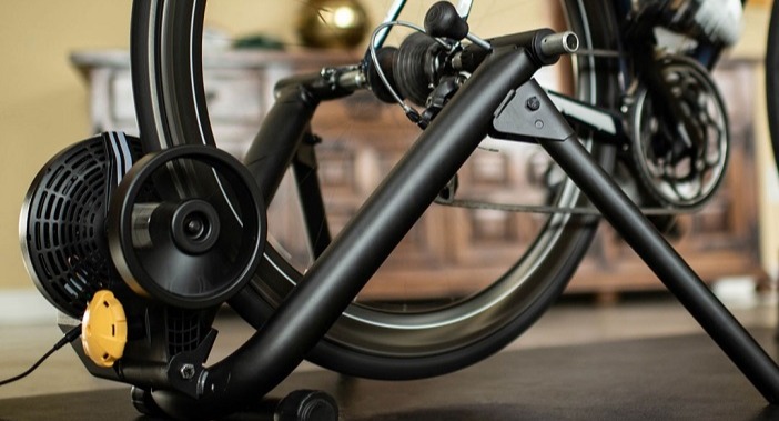 Photo of bicycle sitting on a Saris Brand bicycle Trainer.