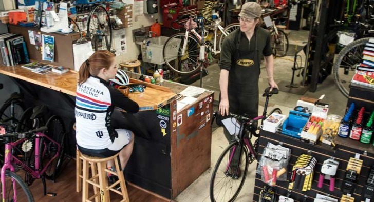 Repair technician delivering a bicycle to a customer