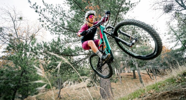 Woman jumping on a mountain bike