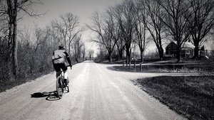 Bike rider on gravel road
