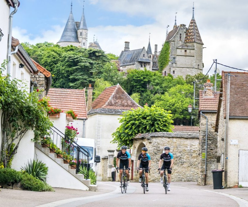 road cyclist riding in a historic village