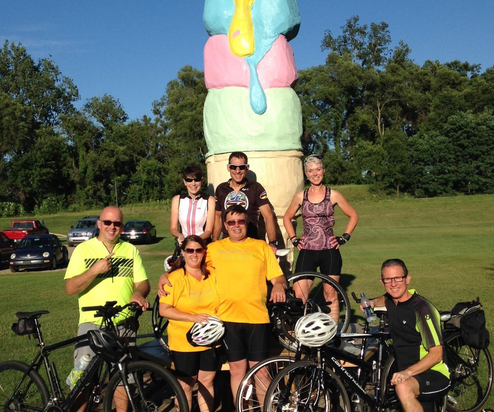 cyclists in front of an ice cream sculpture