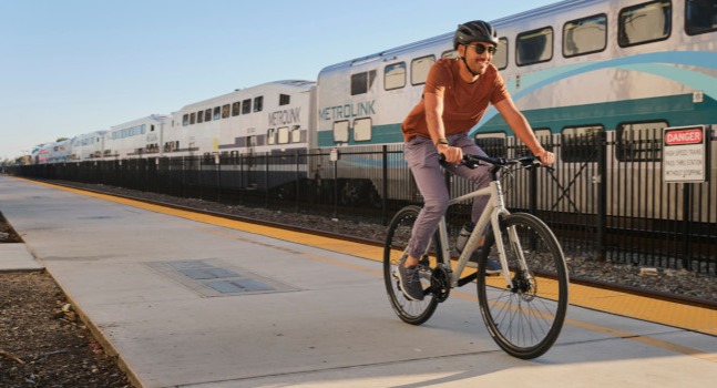 bicycle rental rider passing train