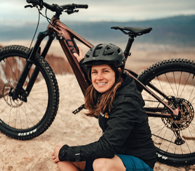 female rider holding liv e-mountain bike