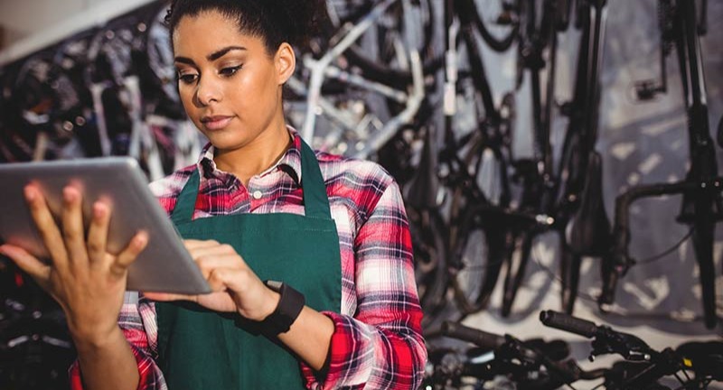 Bicycle store employee using tablet