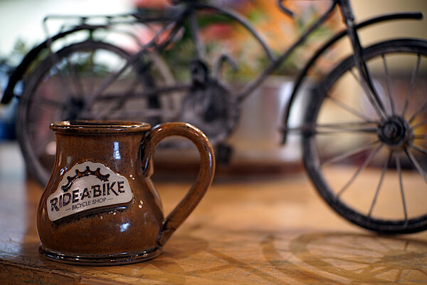 Ride-A-Bike Bicycle Shop Ride-A-Bike Coffee Mug; 10oz; Sandstone (Average Jo) Winter 2021