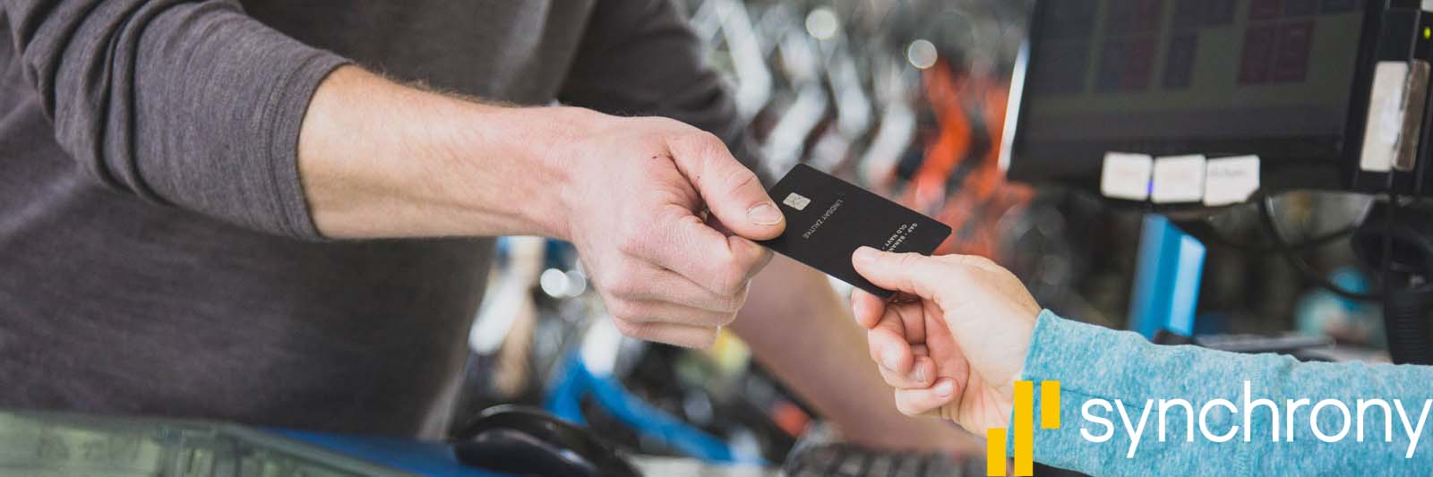 A person handing another person a credit card.