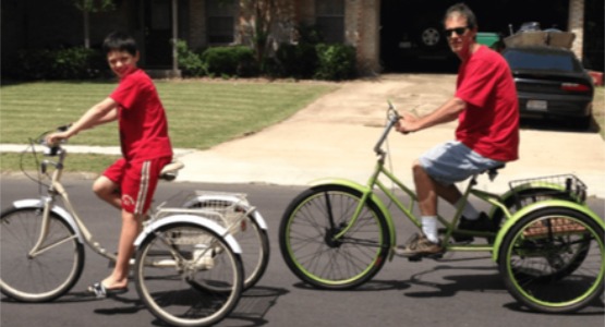 Chris and his son riding adult trikes