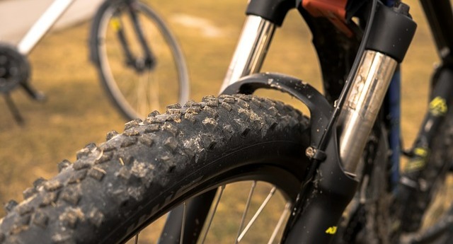 Closeup of a mountain bike tire and suspension