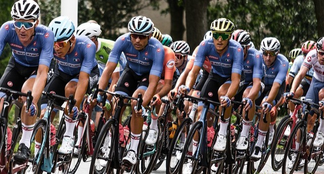 a group of cyclists wearing bike helmets going around a turn at a bike race