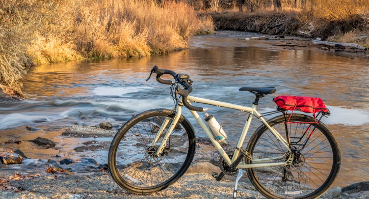 close up of a gravel bike by the edge of a stream