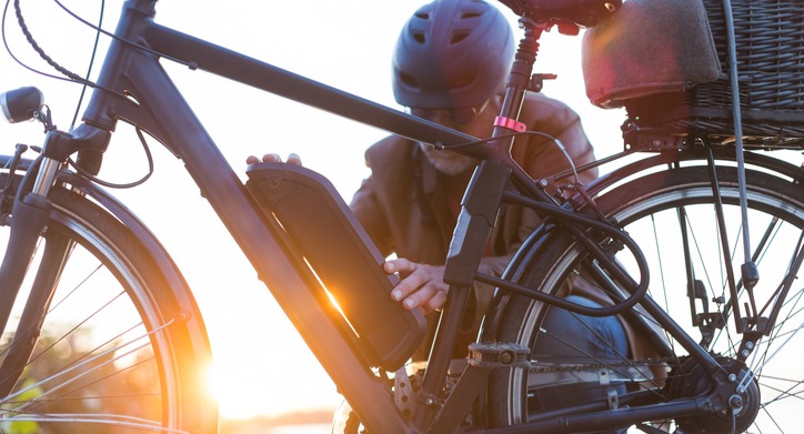 Cyclist checking the battery on his electric bike