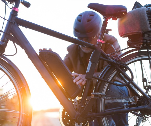Cyclist getting ready to remove his bike's e-battery