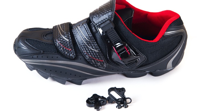 close up a cycling shoe with cleats