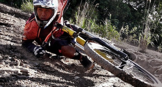 Mountain bike rider leaning into a sharp turn