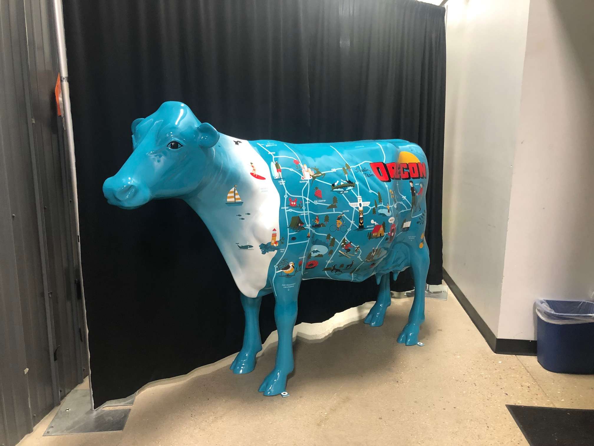 Light blue cow with a map of Oregon highlights