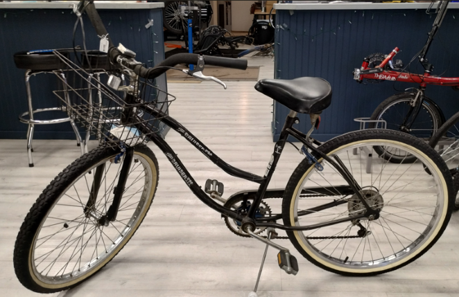 Black cruiser with wire basket. White wall tires