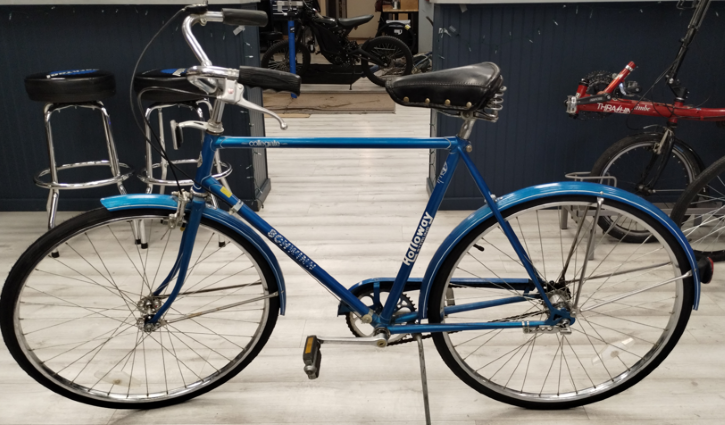Blue frame with fenders, black seat with silver buttons