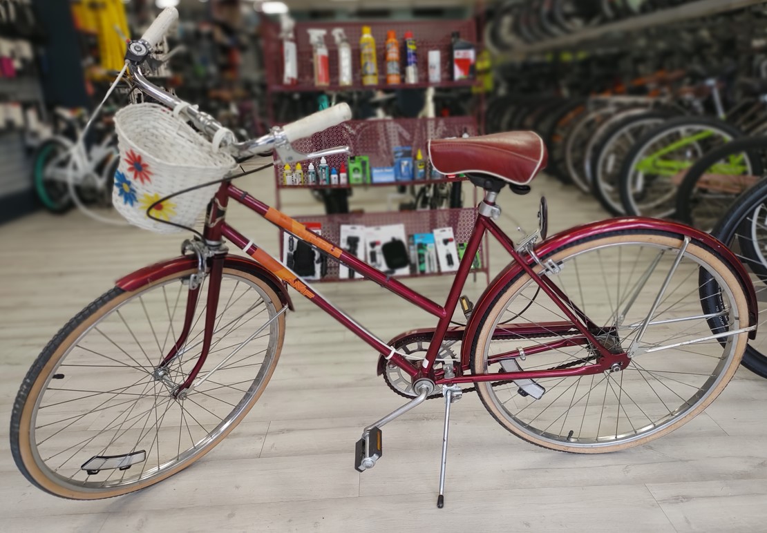 Red stagger step roadmaster with raised handlebars. 