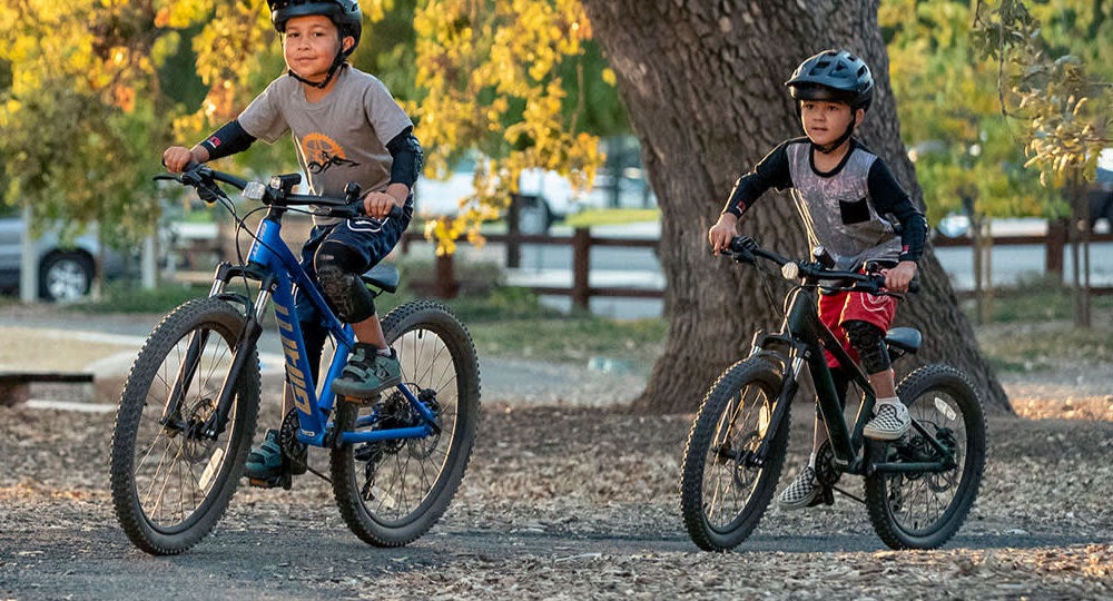 Two kids riding bikes