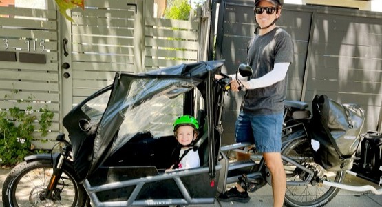 man and kid on cargo bike