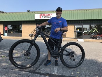 Shane and an e-mtb outside the store