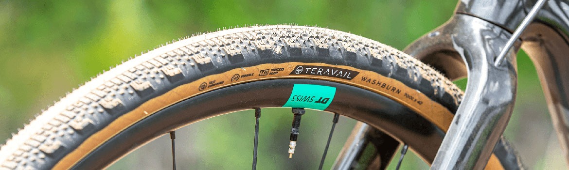 Closeup view of a Teravail Washburn tire being mounted to the front wheel of a bike