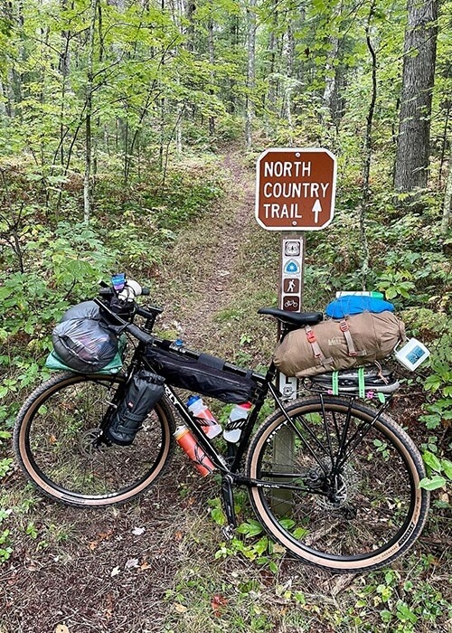 Adam's loaded bike at the start of the North Country Trail. His bike is loaded with packs and gear.