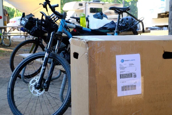Bikes are lined up for an adventure. One is still in its shipping box.