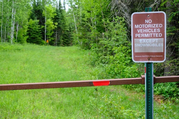 A sign displays that no motorized vehicles are permitted except for snowmobiles