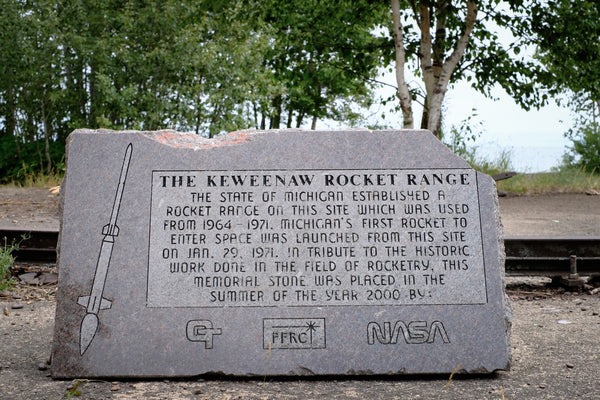 Sign carved into rock displaying the keweenaw rocket range